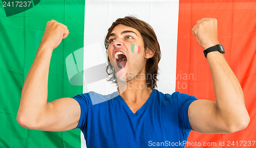 Image of Successful Sportsman Shouting in front of Italian Flag