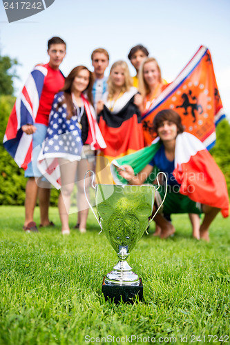 Image of Championship Trophy With Athletes Of Various Nations