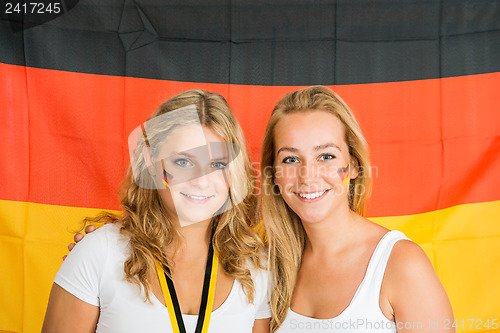 Image of Sportswomen Standing Against German Flag