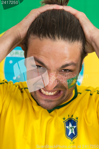 Image of Brazilian sports fan in dispair