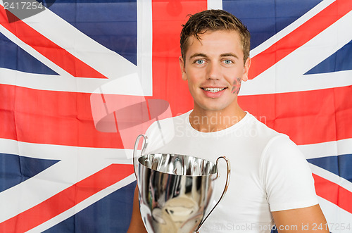 Image of Sportswoman With Trophy Standing Against British Flag