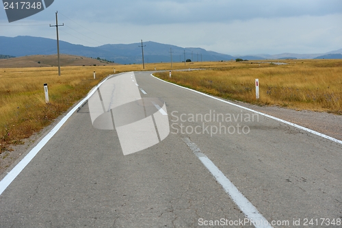 Image of road through the green field