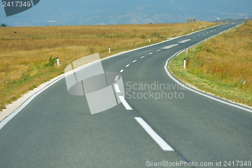 Image of road through the green field