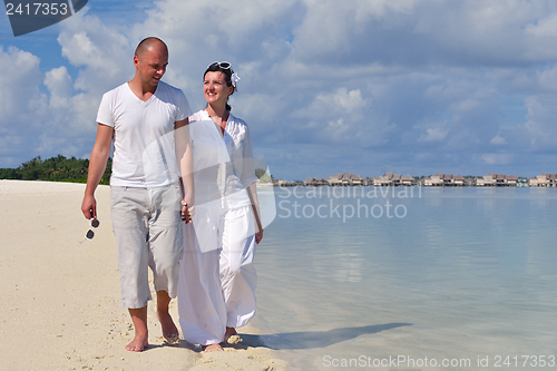 Image of happy young couple have fun on beach