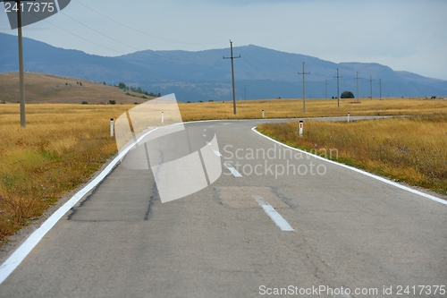 Image of road through the green field