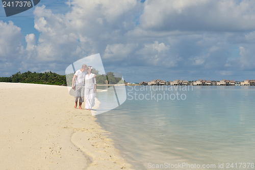 Image of happy young couple have fun on beach