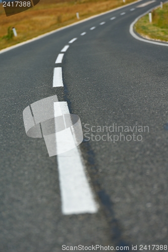 Image of road through the green field