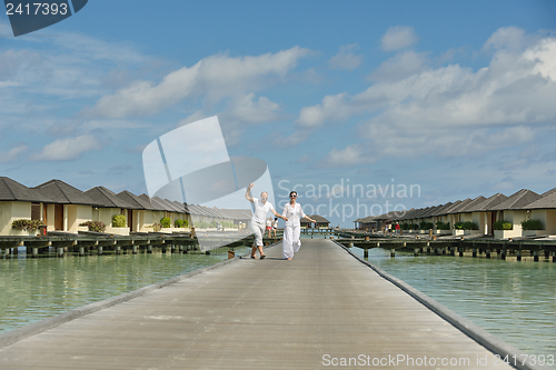 Image of happy young couple have fun on beach