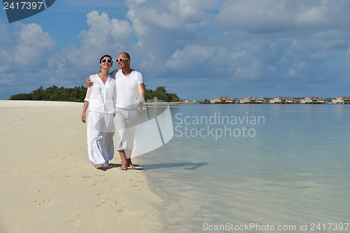 Image of happy young couple have fun on beach