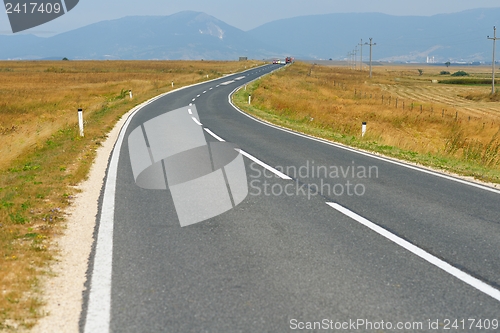 Image of road through the green field