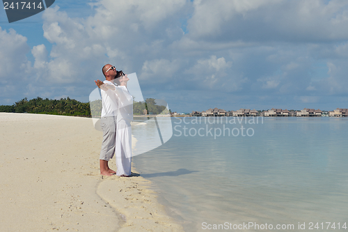 Image of happy young couple have fun on beach
