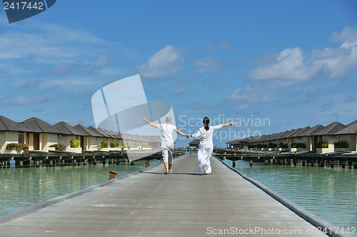 Image of happy young couple have fun on beach