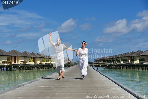 Image of happy young couple have fun on beach