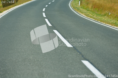 Image of road through the green field