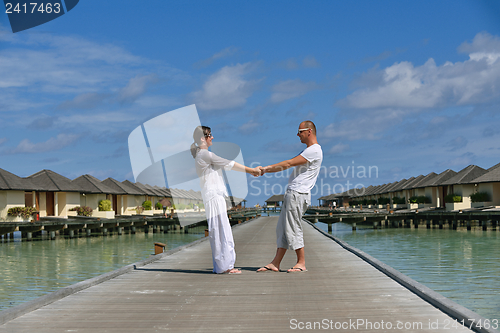 Image of happy young couple have fun on beach