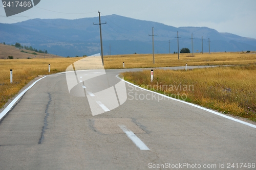 Image of road through the green field