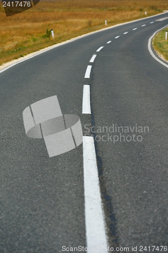 Image of road through the green field