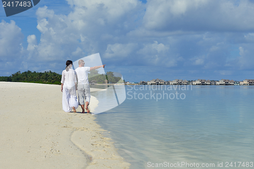 Image of happy young couple have fun on beach