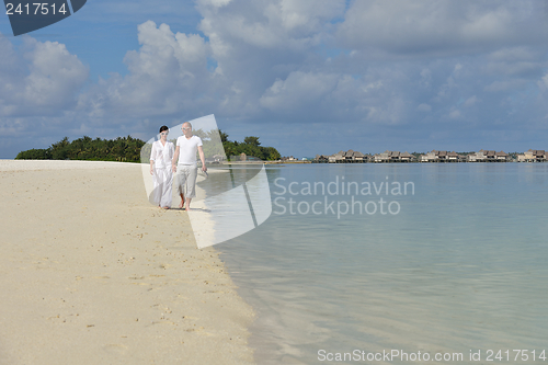 Image of happy young couple have fun on beach