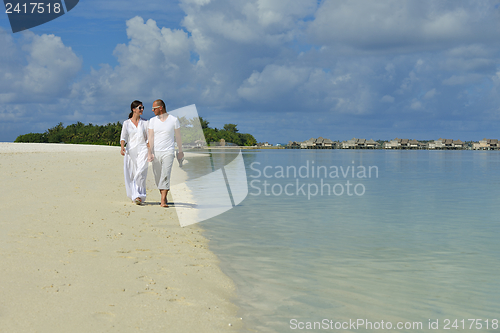 Image of happy young couple have fun on beach