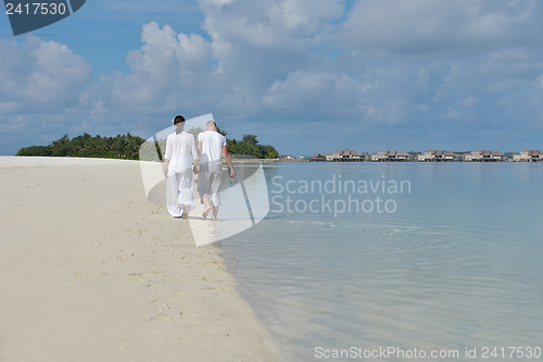Image of happy young couple have fun on beach