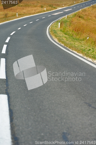 Image of road through the green field