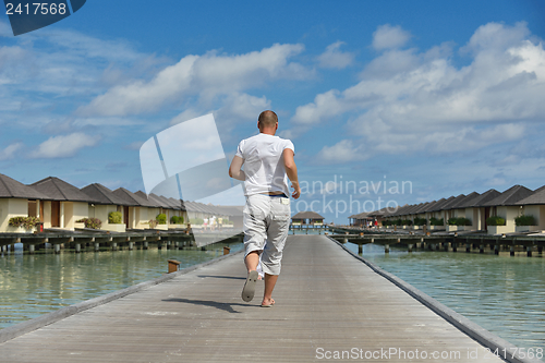 Image of happy young couple have fun on beach