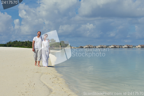 Image of happy young couple have fun on beach