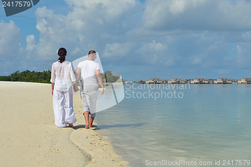 Image of happy young couple have fun on beach