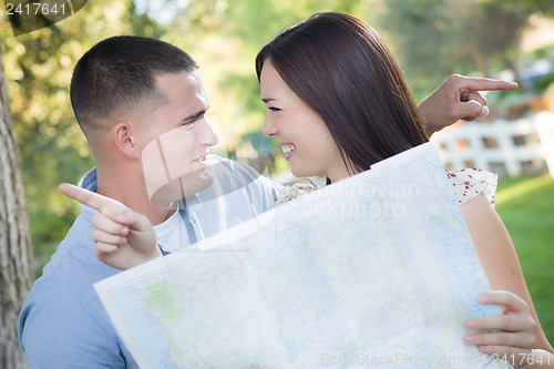 Image of Lost and Confused Mixed Race Couple Looking Over Map Outside