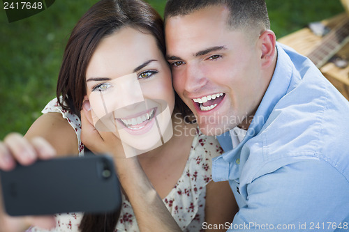 Image of Mixed Race Couple Taking Self Portrait in Park