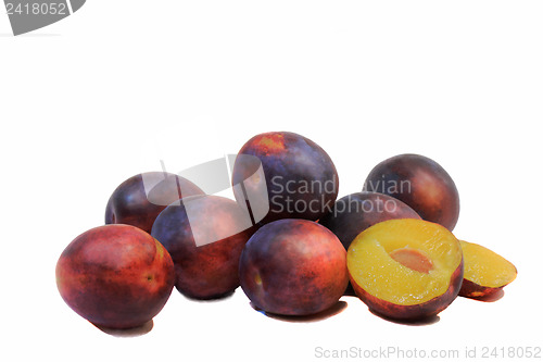 Image of Large ripe plums on a white background.