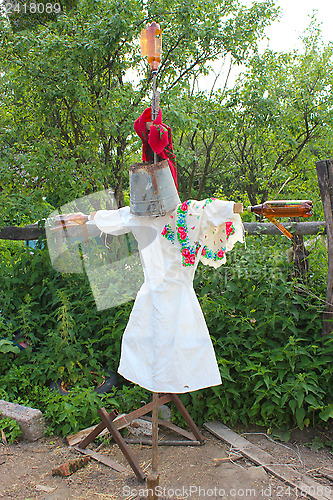 Image of motley scarecrow in white docktor's smock