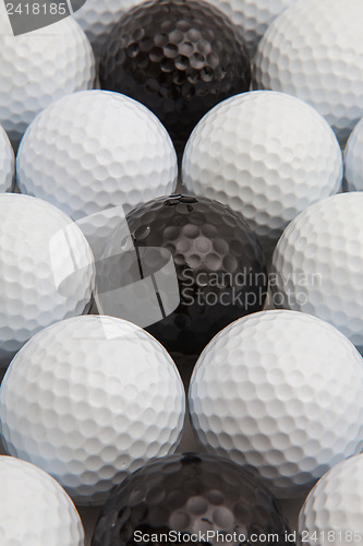Image of White and black golf balls and wooden tees