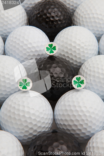 Image of White and black golf balls and wooden tees