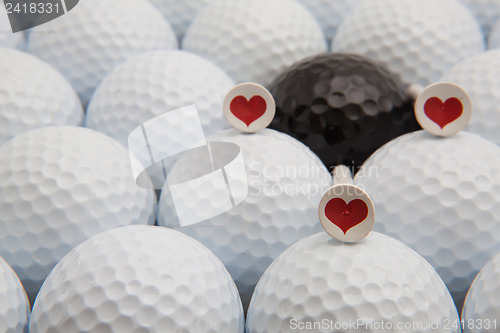 Image of Different golf balls and romantic tees