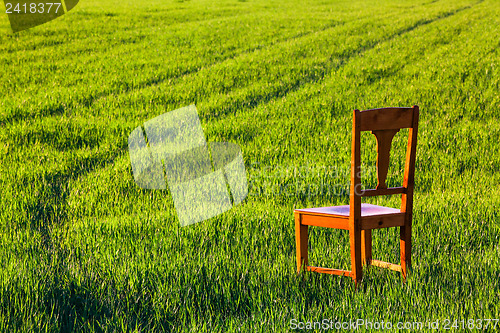 Image of Abandoned chair on the field