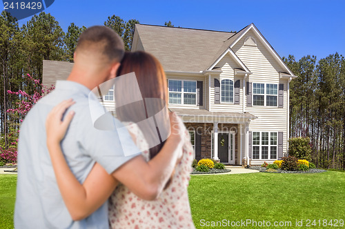 Image of Military Couple Looking at Nice New House