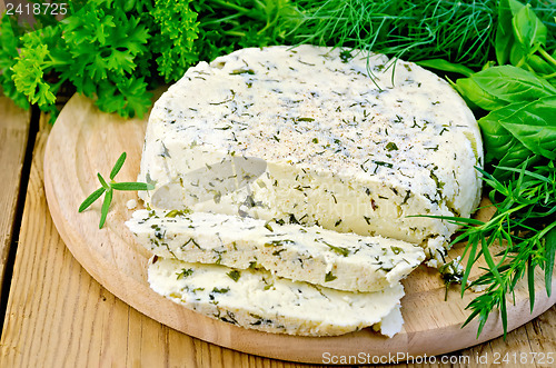 Image of Cheese round homemade with herbs chopped