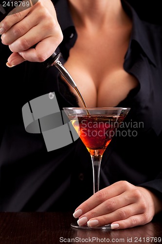 Image of Barmaid mixing drink