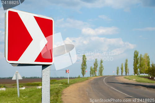 Image of Picture of asphalt countryside road with sign