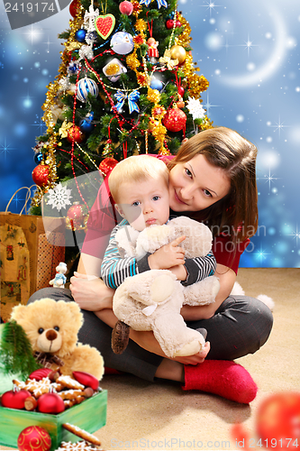 Image of Christmas - happy young woman with a child.