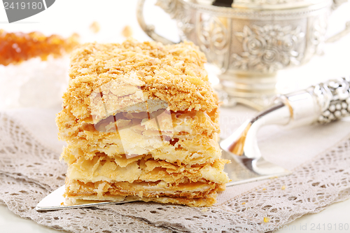 Image of Silver blade with a cake of puff pastry.