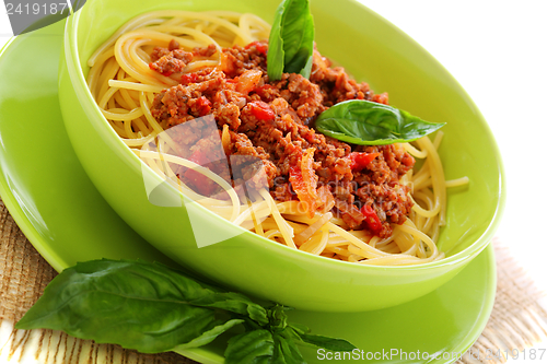 Image of Pasta with tomatoes, meat and basil.
