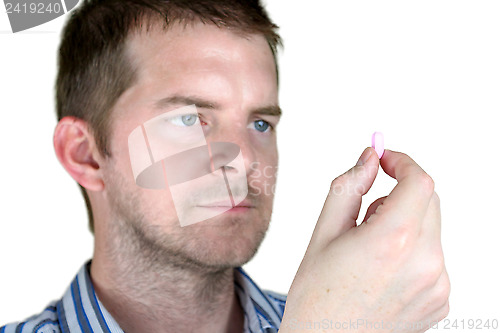 Image of Man holding a Pill