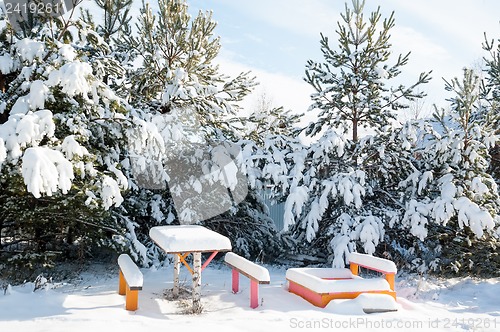 Image of benches with table in the snow