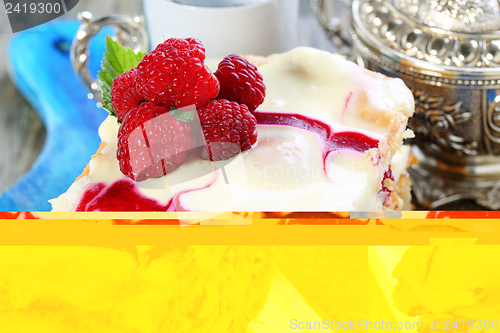 Image of Puff pastry cake decorated with raspberries.