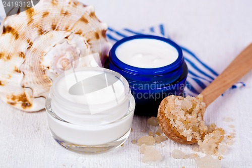 Image of face cream in jars with sea salt and shell 