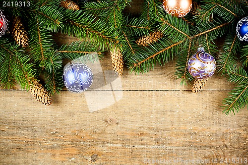 Image of christmas fir tree with pinecones and decorations 