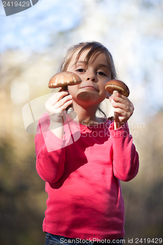 Image of Little girl with mushrooms